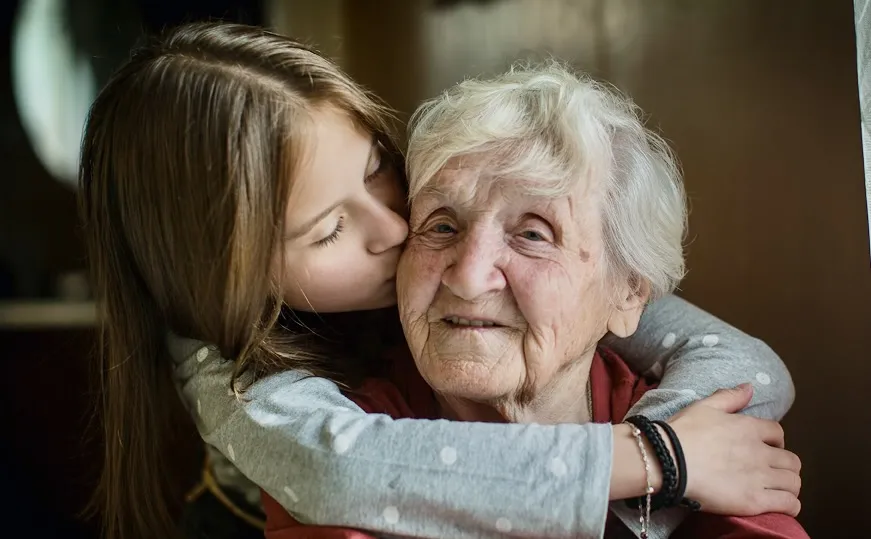 grandmother and grandaughter hug